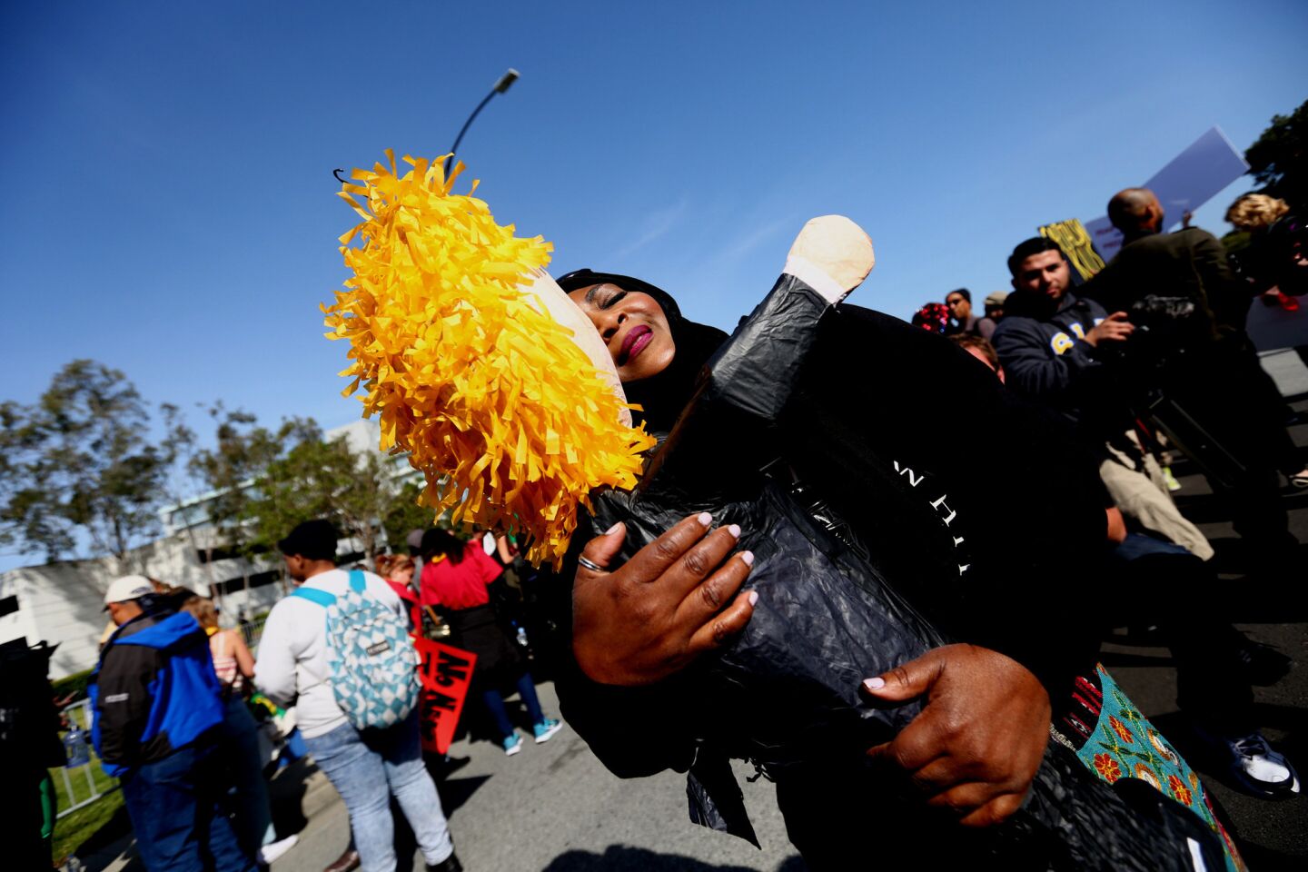 Rabia Keeble hugs a Donald Trump piñata during a protest outside the California Republican Party convention in Burlingame.