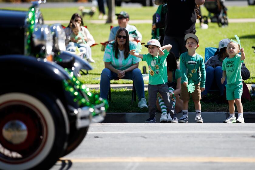 Mason, 5; Braxton, 5; and Mateo, 3, cheer as parade participants pass by during the 41st annual St. Patrick’s Day Parade and Festival by Balboa Park on Saturday, March 16, 2024