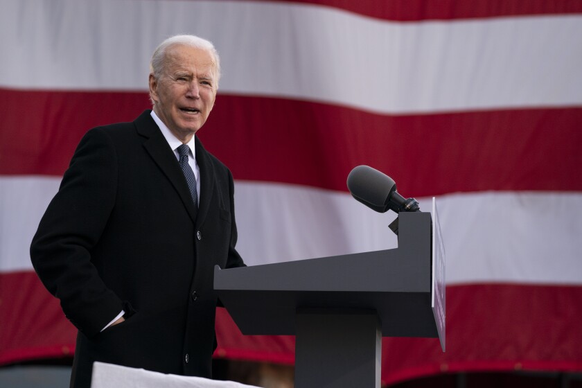 Joe Biden speaking at lectern