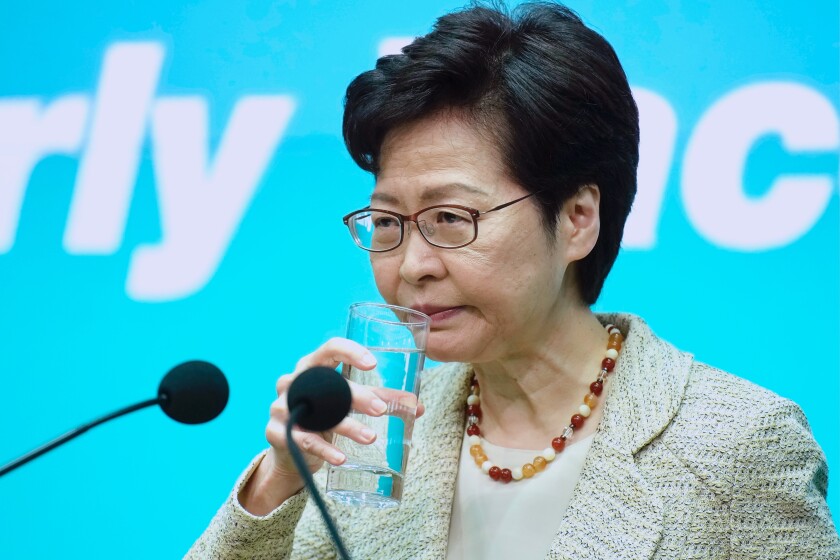 Hong Kong Chief Executive Carrie Lam drinks water during a press conference in Hong Kong, Tuesday, June 15, 2021. Lam said that her government is “highly concerned” about the situation at a nearby nuclear power plant in mainland China, following media reports that the plant could be experiencing a leak. (AP Photo/Vincent Yu)