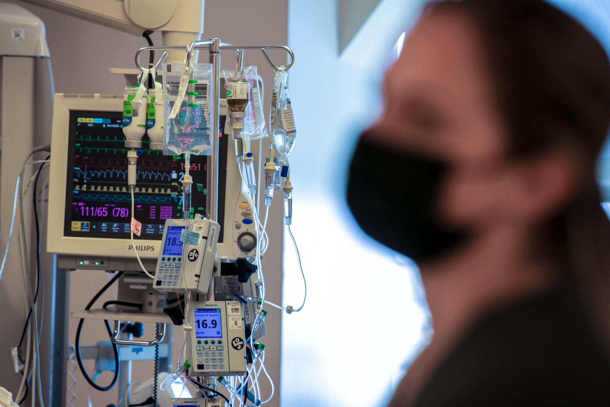 Registered nurse Robert Alderete monitors intravenous pumps delivering medications.