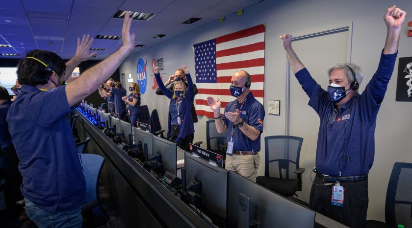 Members of NASA's Perseverance rover team celebrate its safe landing