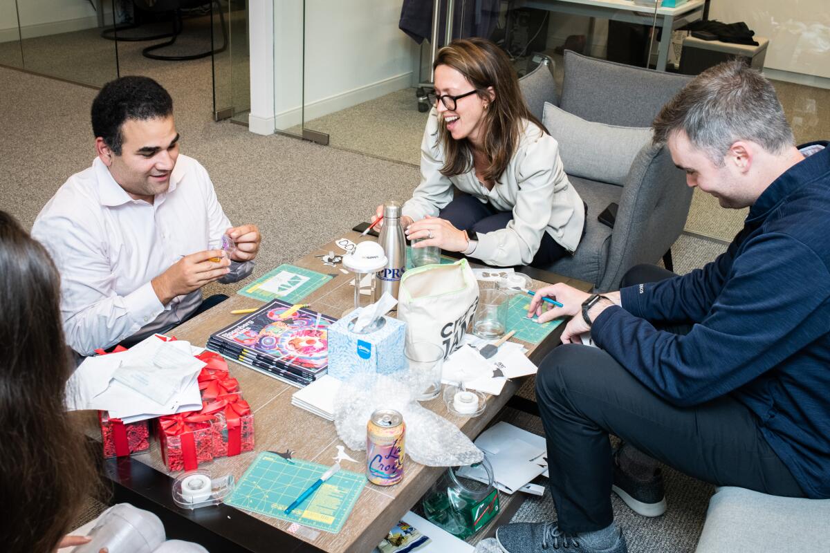 People crafting around a table.