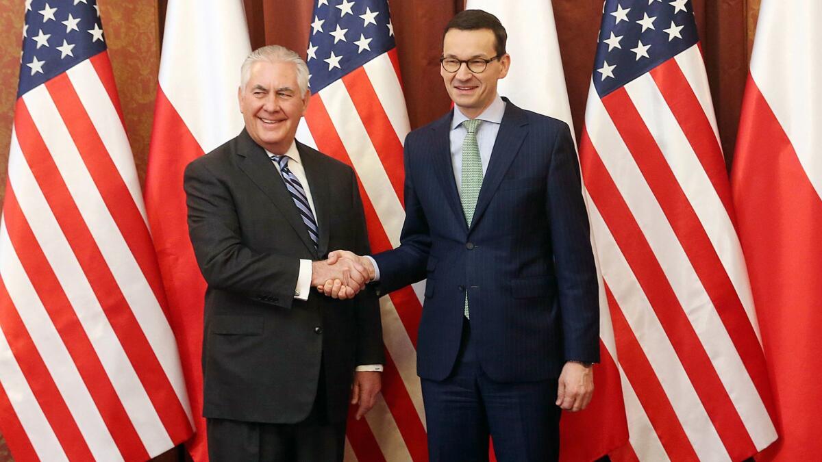 Secretary of State Rex Tillerson, left, shakes hands with Polish Prime Minister Mateusz Morawiecki.
