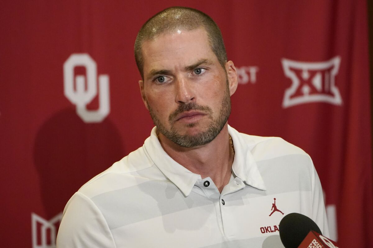 FILE - Oklahoma defensive coordinator Alex Grinch speaks during an NCAA college football news conference Tuesday, Aug. 31, 2021, in Norman, Okla. Southern California coach Lincoln Riley confirmed his full coaching staff for his debut season with the Trojans on Monday, Jan. 10, 2022. Riley's new staff is headlined by Alex Grinch, his defensive coordinator and safeties coach. Grinch followed Riley from Oklahoma last month, taking the same private plane to Los Angeles after three seasons together with the Sooners. (AP Photo/Sue Ogrocki, File)