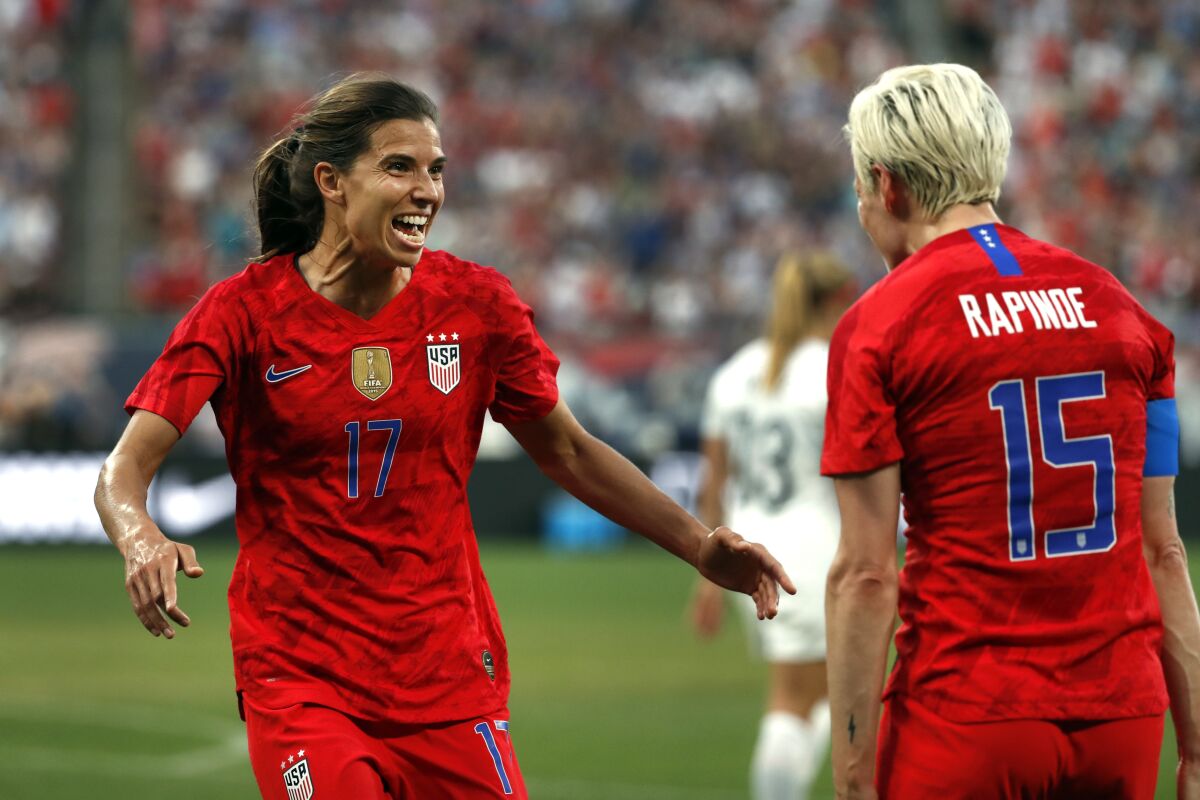 FILE - United States' Tobin Heath, left, is congratulated by teammate Megan Rapinoe after scoring during the first half of an international friendly soccer match against New Zealand on May 16, 2019, in St. Louis. National Women's Soccer League team OL Reign has acquired the rights to Heath from Racing Louisville on Thursday, June 16, 2022. The Reign signed Heath for the rest of the NWSL season, with an option for 2023. (AP Photo/Jeff Roberson, File)