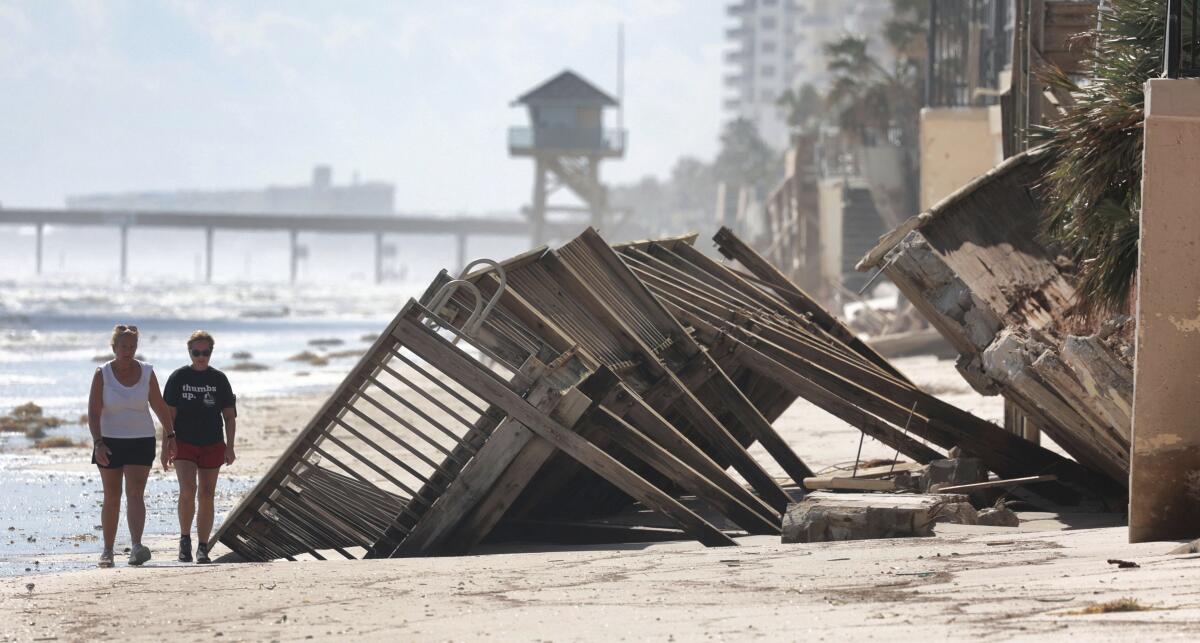 Beachgoers survey Hurricane Ian damage