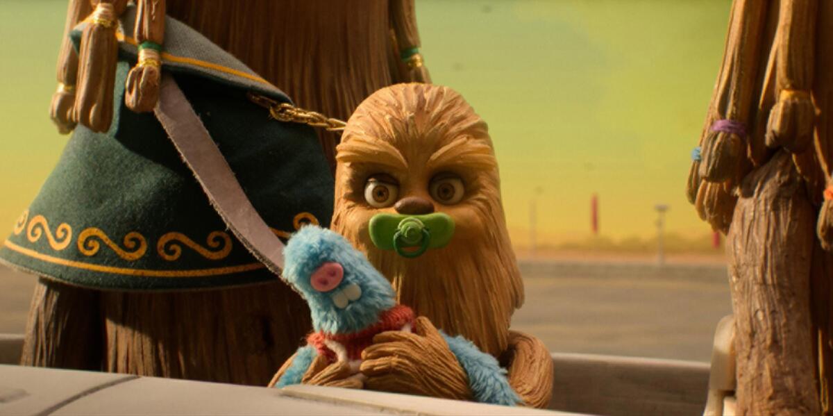 An animated baby Wookiee holding a doll.