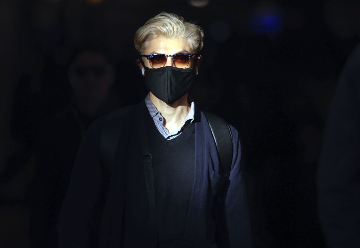 A man in sunglasses and a mask
