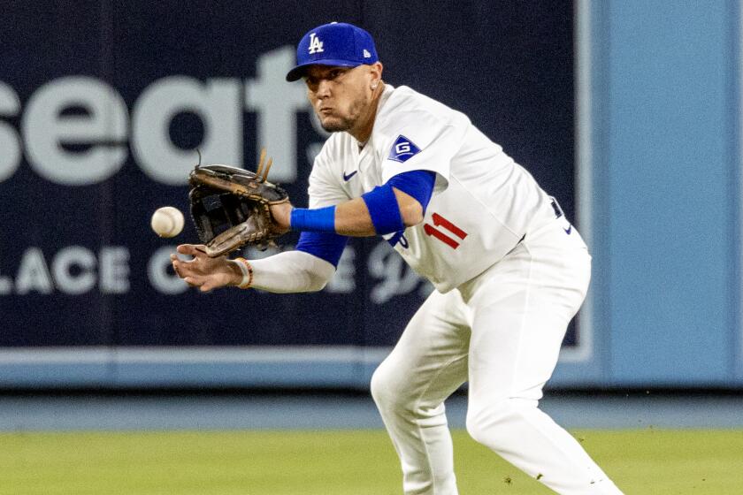 LOS ANGELES, CA - MAY 7, 2024: Los Angeles Dodgers shortstop Miguel Rojas (11) fields the ball.