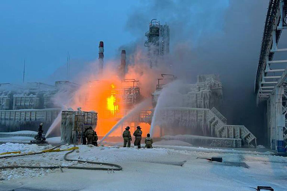 Firefighters extinguish a blaze at a snow-covered natural gas site in Russia.