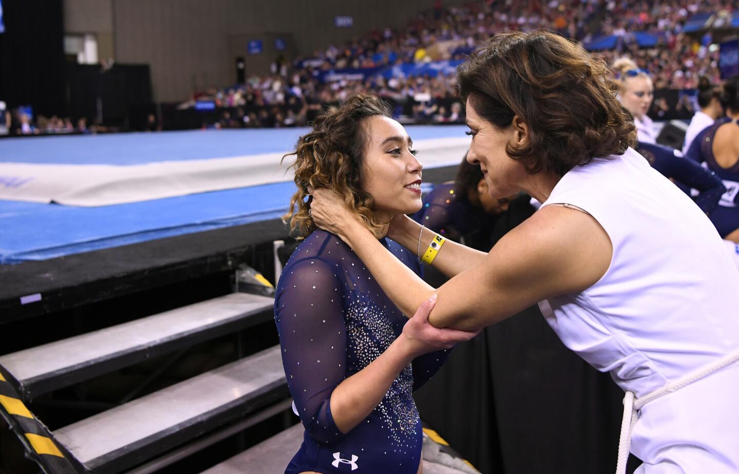 Katelyn Ohashi is held by Coach Valorie Kondros Field after Ohashi's last floor routine as a senior Saturday at the NCAA gymnastics championship in Fort Worth, Texas.