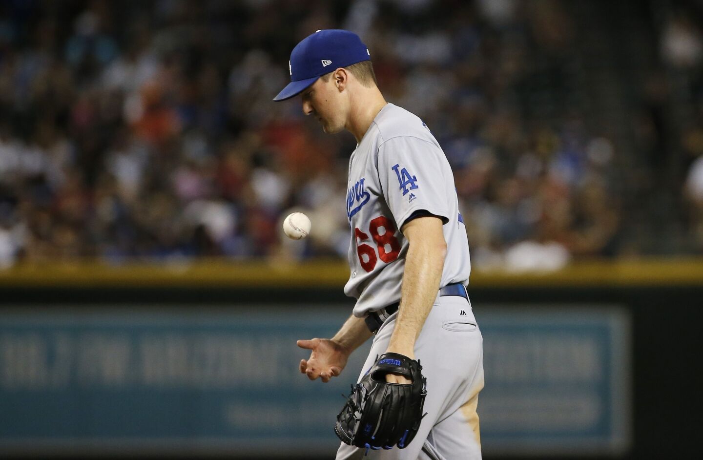 Los Angeles Dodgers pitcher Ross Stripling flips the ball in the air after giving up an RBI single to Arizona Diamondbacks' Zack Greinke during the second inning of a baseball game Wednesday, Sept. 26, 2018, in Phoenix. (AP Photo/Ross D. Franklin)
