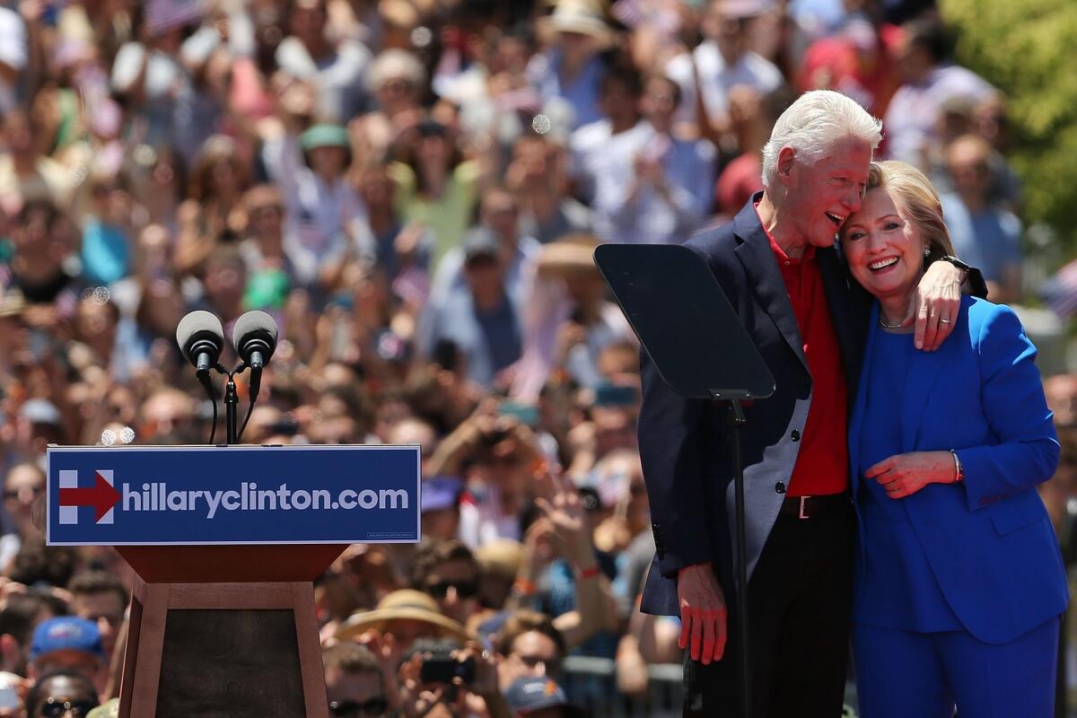 Hillary Rodham Clinton stands on stage with her husband after her official kickoff rally this month.