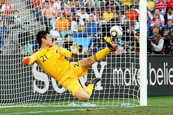 Eiji Kawashima of Japan looks on as a shot from Wesley Sneijder of the Netherlands hits the back of the net during their match Saturday. Netherlands won, 1-0.