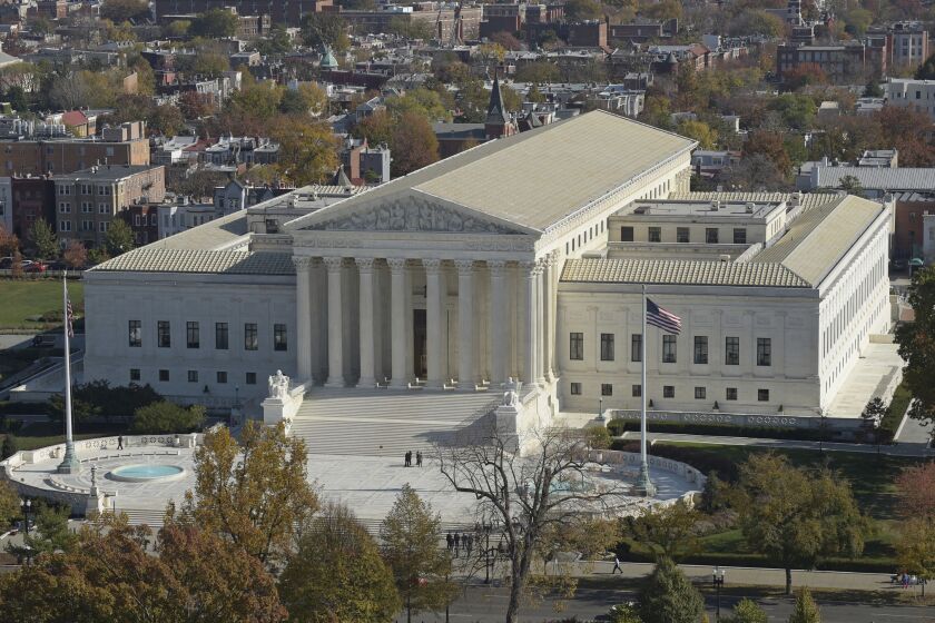 This Nov. 15, 2016 photo shows a view of the Supreme Court from the Capitol Dome, on Capitol Hill in Washington. An Asian-American rock band called the Slants has spent years locked in a legal battle with the government over its refusal to trademark the bandâs name. The fight will play out Wednesday at the Supreme Court as the justices consider whether a law barring disparaging trademarks violates the band's free speech rights. (AP Photo/Susan Walsh)