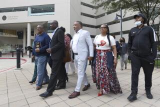 FILE - Attorney Ben Crump, second from left, walks with Ron Lacks, left, Alfred Lacks Carter, third from left, both grandsons of Henrietta Lacks, and other descendants of Lacks, outside the federal courthouse in Baltimore, Oct. 4, 2021. The family of Henrietta Lacks is settling a lawsuit against a biotechnology company it accuses of improperly profiting from her cells. Their federal lawsuit in Baltimore claimed Thermo Fisher Scientific has made billions from tissue taken without the Black woman’s consent from her cervical cancer tumor. (AP Photo/Steve Ruark, file)