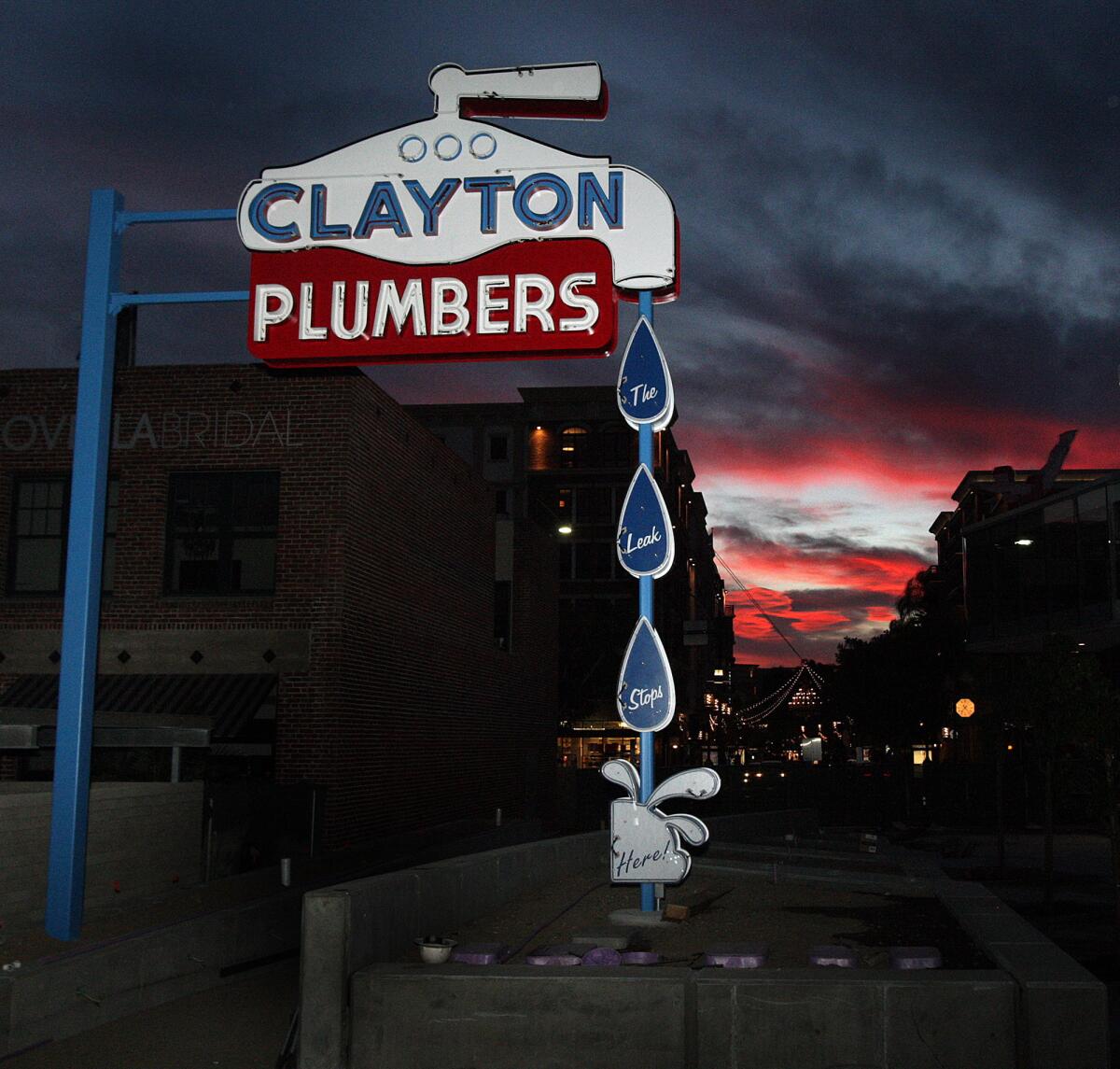 A Clayton Plumbers sign, which hasn't yet been illuminated, has been erected next to the Neon Art Museum in Glendale on Tuesday, March 24, 2015.