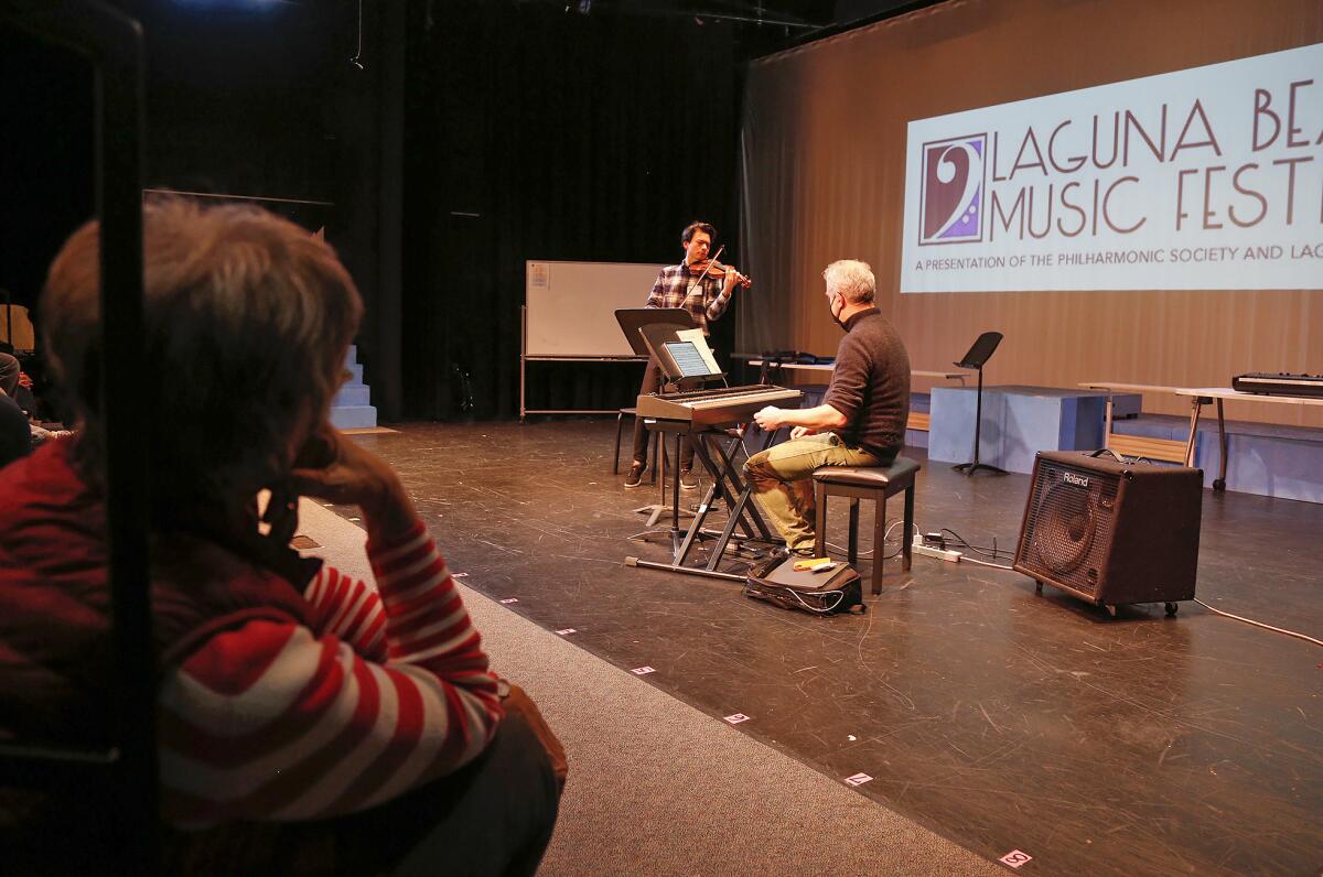 Violinist Stefan Jackiw joins pianist Jeremy Denk as they perform for kids at Thurston Middle School on Thursday.