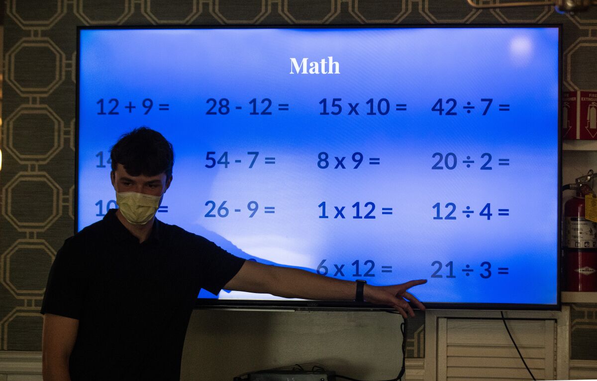 Eddie Nash pointed to a large illuminated screen with math problems on it.