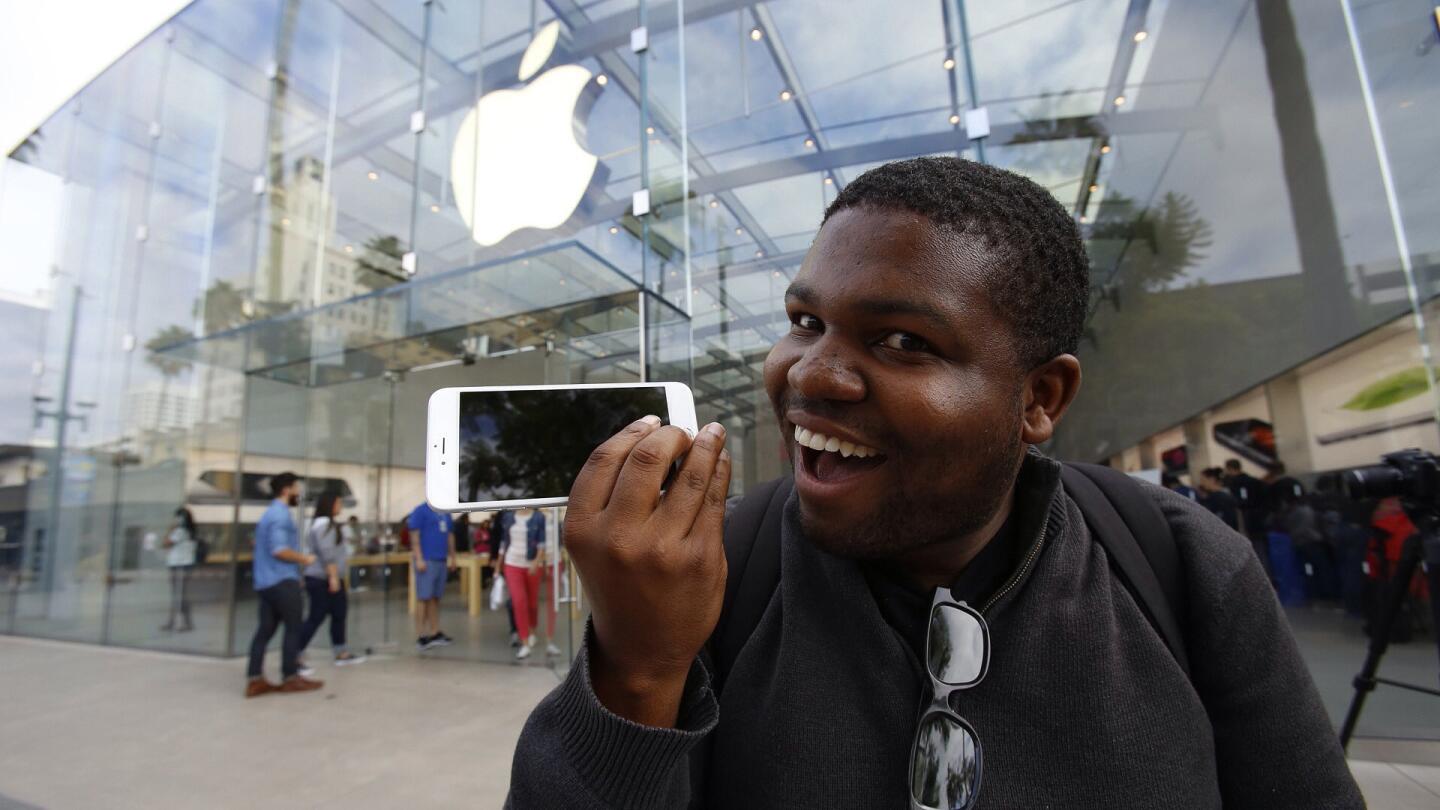 Daniel Freeman shows off the new iPhone 6 Plus he picked up Sept. 19 after waiting in line for two days at the Santa Monica Apple Store.
