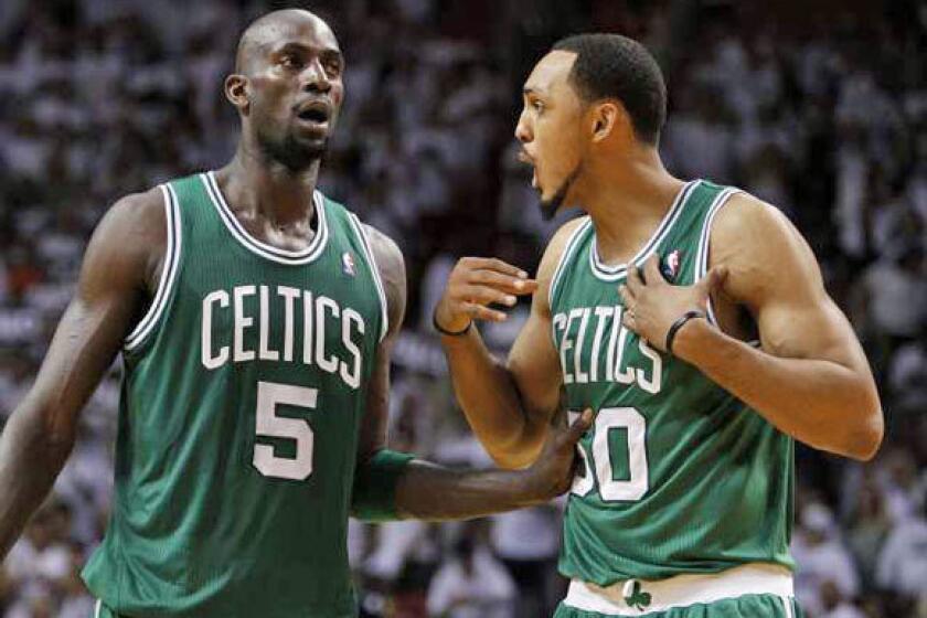 Kevin Garnett, left, and Ryan Hollins with the Celtics last season.