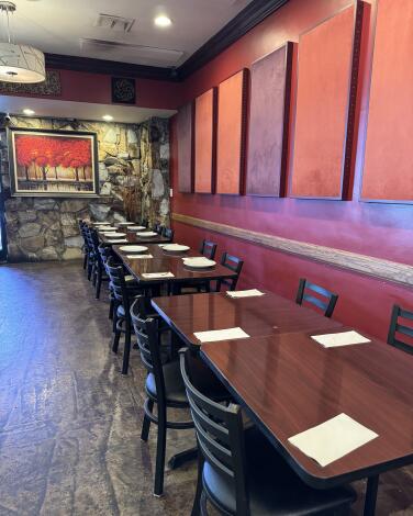 Tables at the entrance of Lum Ka Naad's cozy Northridge interior dining space.