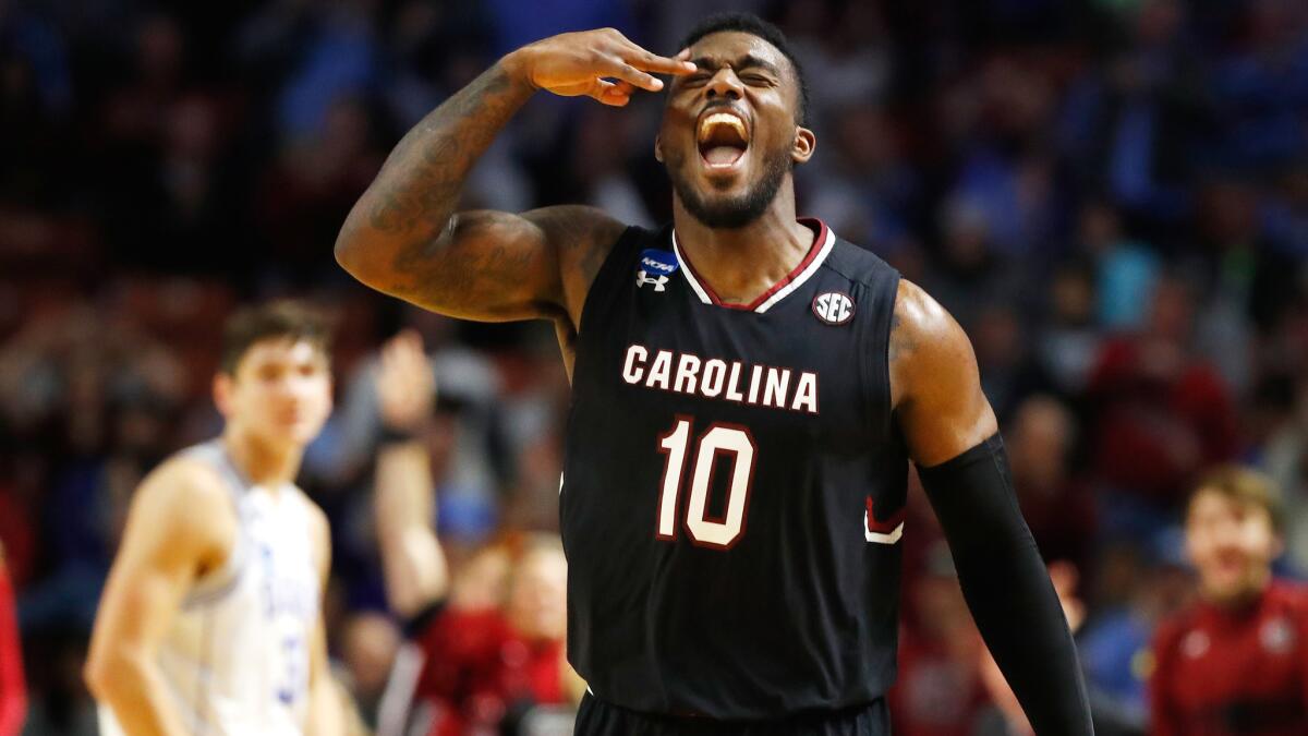 South Carolina guard Duane Notice celebrates after making a three-pointer against Duke during the second half Sunday.