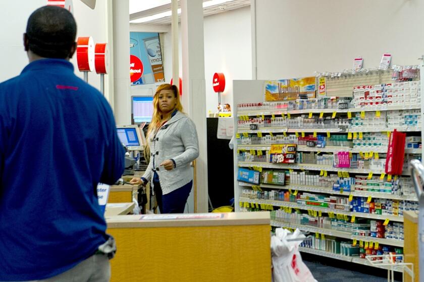 A clerk mans the cigarette counter at a CVS drugstore in Washington.