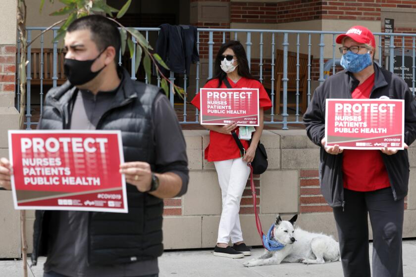 SANTA MONICA, CA - APRIL 13: Nurses hold a rally at Santa Monica UCLA Medical Center and Orthopaedic (cq) Hospital on Monday, April 13, 2020 in Santa Monica, CA to draw attention to their need for more PPE, to demand adherence to state mandated nurse to patient ratios at all times and to ensure full employment for all healthcare workers during the coronavirus pandemic. (Myung J. Chun / Los Angeles Times)