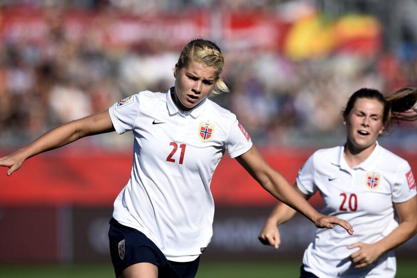 Norway forward Ada Hegerberg (21) celebrates one of her two goals against Ivory Coast with teammate Emilie Haavi on Monday.