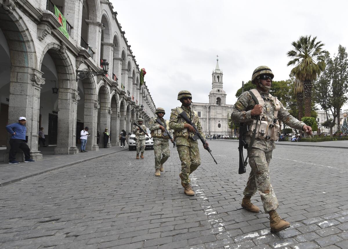Soldiers march in a Peru city square.