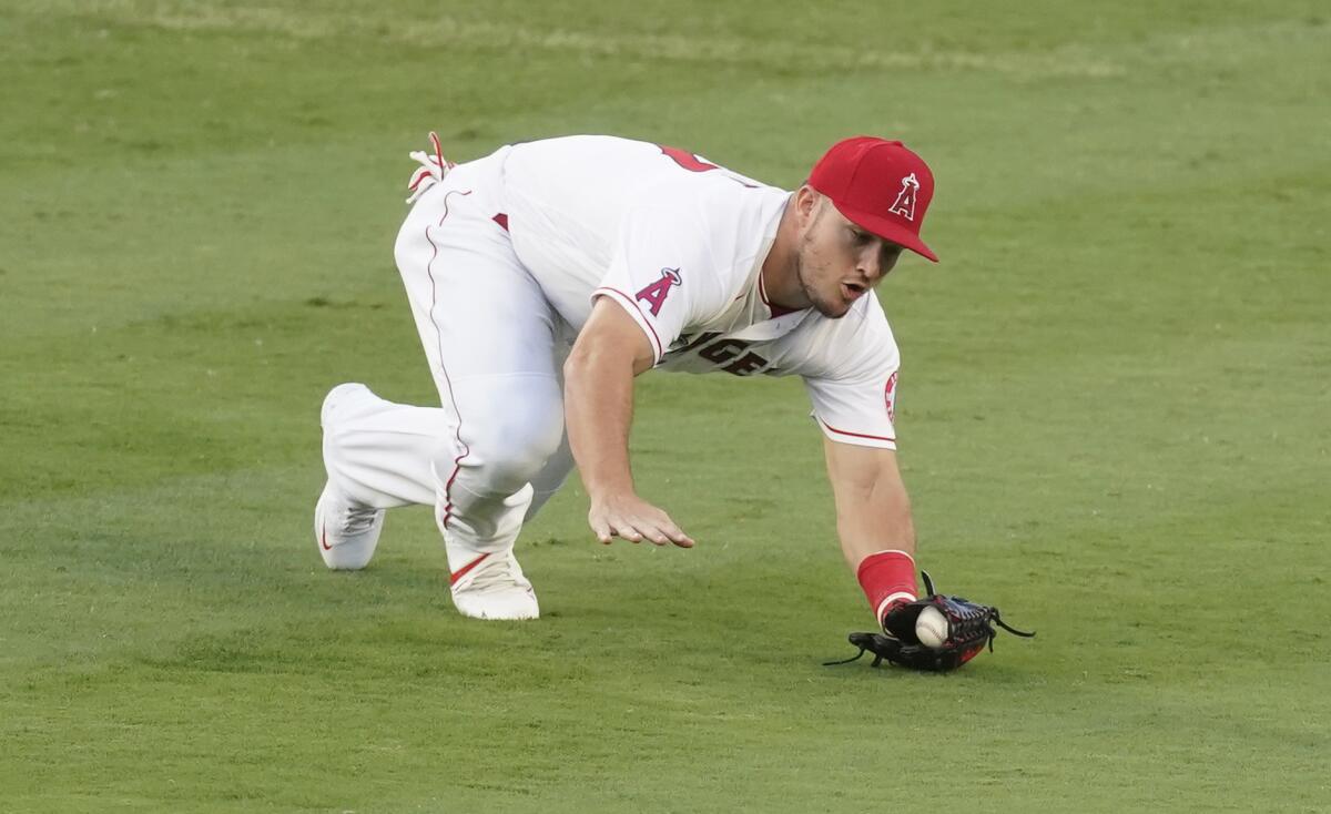 Angels center fielder Mike Trout reaches to catch a ball against the Rangers.