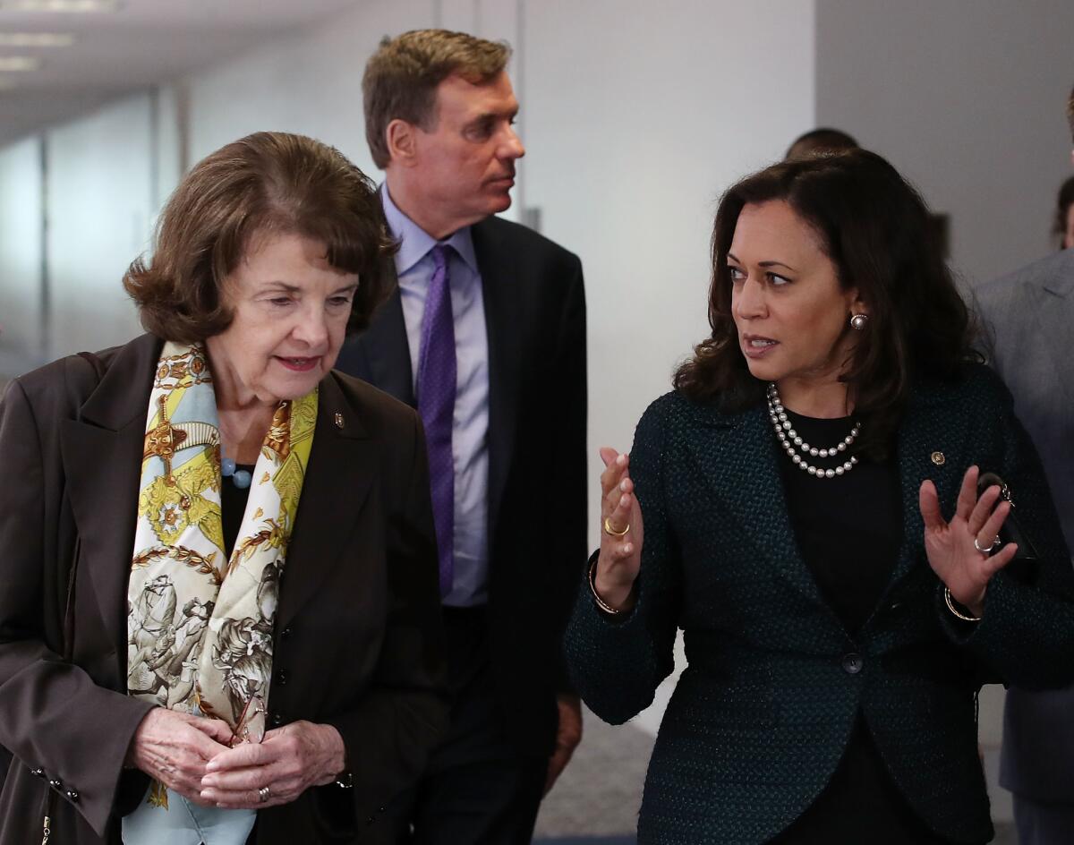 California Sens. Dianne Feinstein, left, and Kamala Harris walk together.