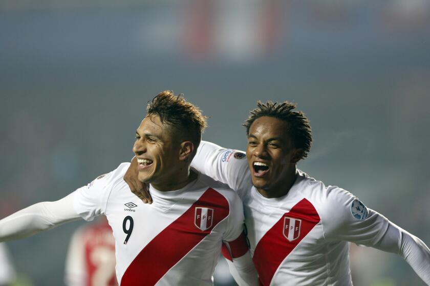 Peru's Jose Paolo Guerrero, left, celebrates with teammate Andre Carrillo after scoring his team's second goal during the soccer match for the third place of the Copa America at the Ester Roa Rebolledo Stadium in Concepcion, Chile, Friday, July 3, 2015. Peru beat Paraguay 2-0 in a play-off match.(AP Photo/Andre Penner)