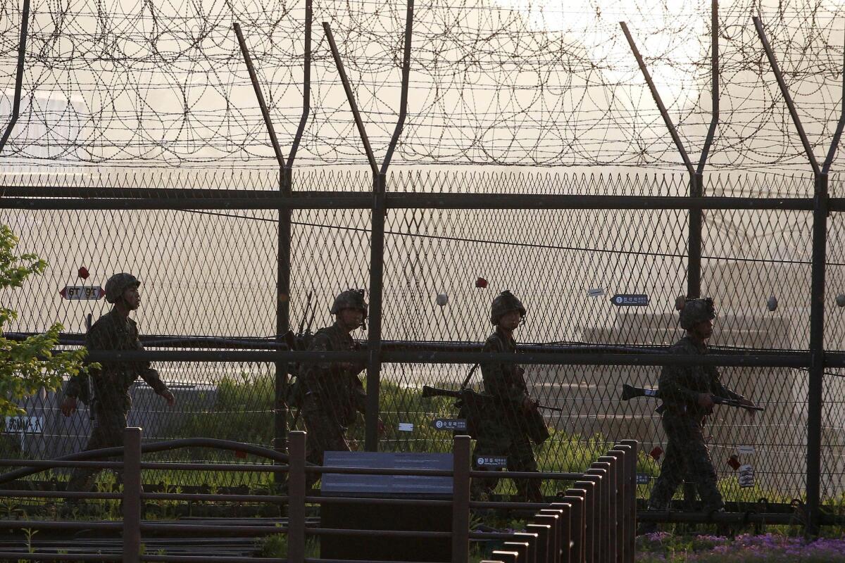 South Korean soldiers patrol along a barbed-wire fence near the village of Panmunjom, on the border with North Korea.