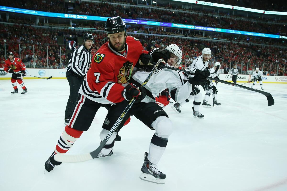Blackhawks defenseman Brent Seabrook and Kings forward Tanner Pearson battle for position and the puck as they head to the corner in the first period.