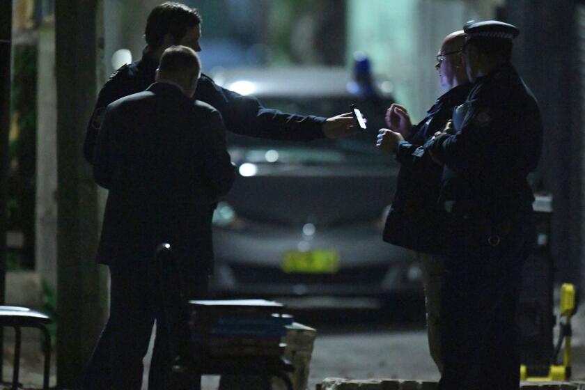 Australian Federal Police and NSW Police officers work in the Surry Hills suburb of Sydney, Australia on Saturday, July 29, 2017. Law enforcement officials raided properties in several Sydney suburbs and arrested four men on suspicion of plotting a terrorist attack related to a bomb plot involving aircraft, officials said. (Sam Mooy/AAP Image via AP)