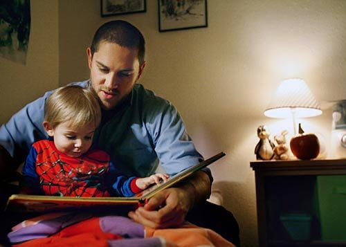 Jeromy Emerling reads a story before bedtime to his 2-year-old son Eli.