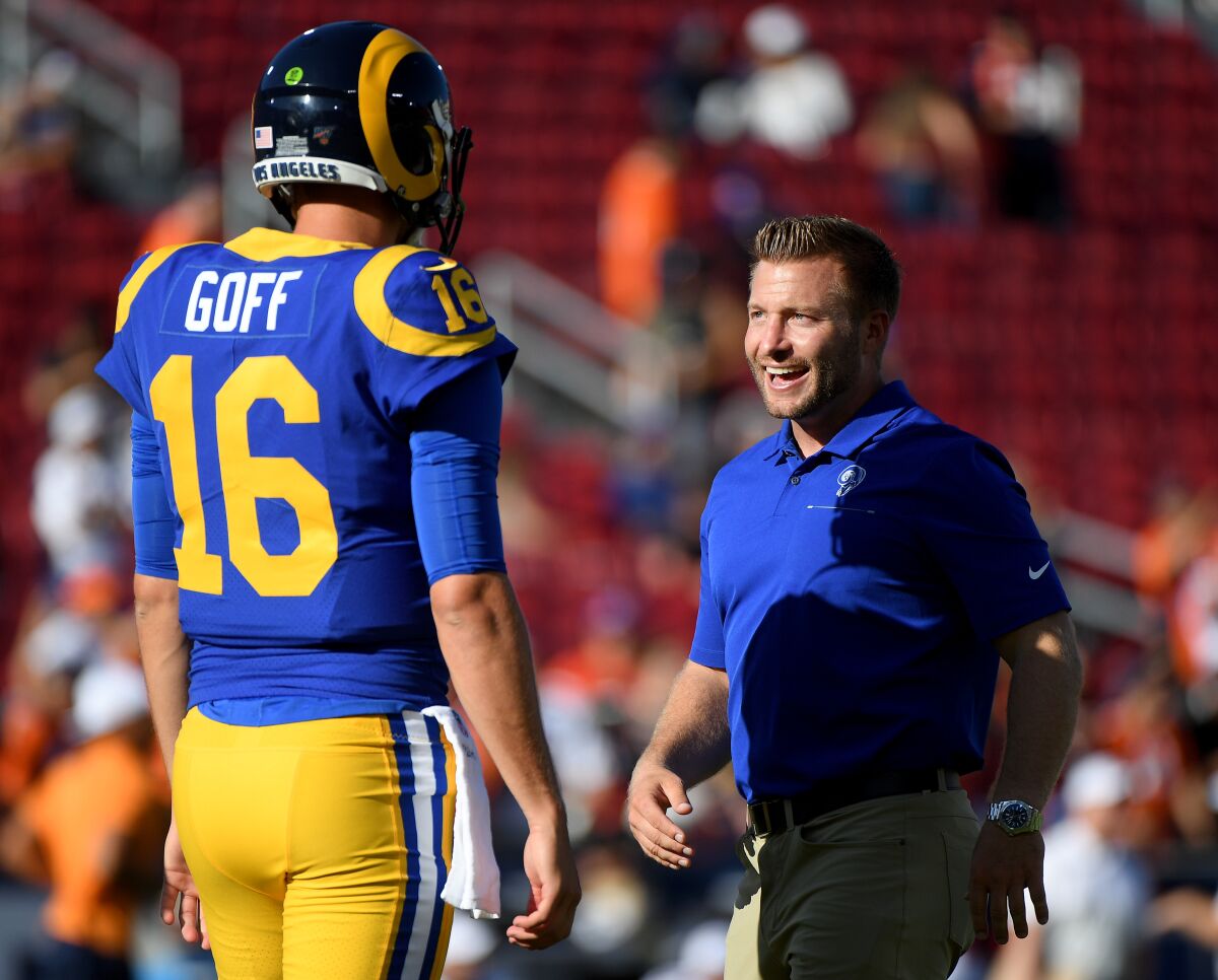 Rams head coach Sean McVay laughs with quarterback Jared Goff before a preseason game at the Coliseum on Aug. 24.