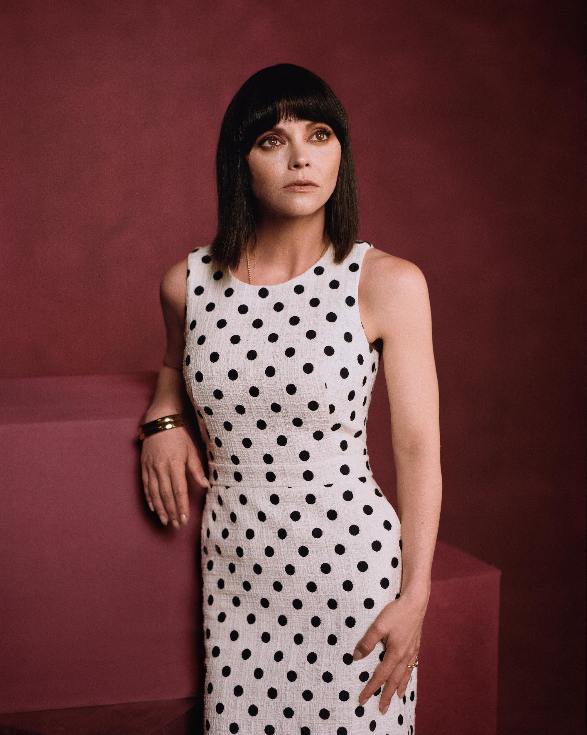 Actress Christina Ricci in a polka-dot dress poses for a portrait.