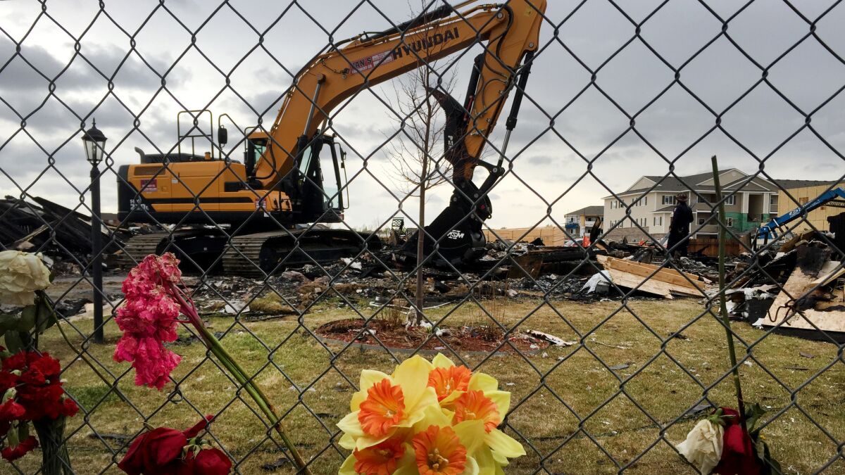 Heavy equipment removes debris from a house that exploded in Firestone on April 17, killing two people.