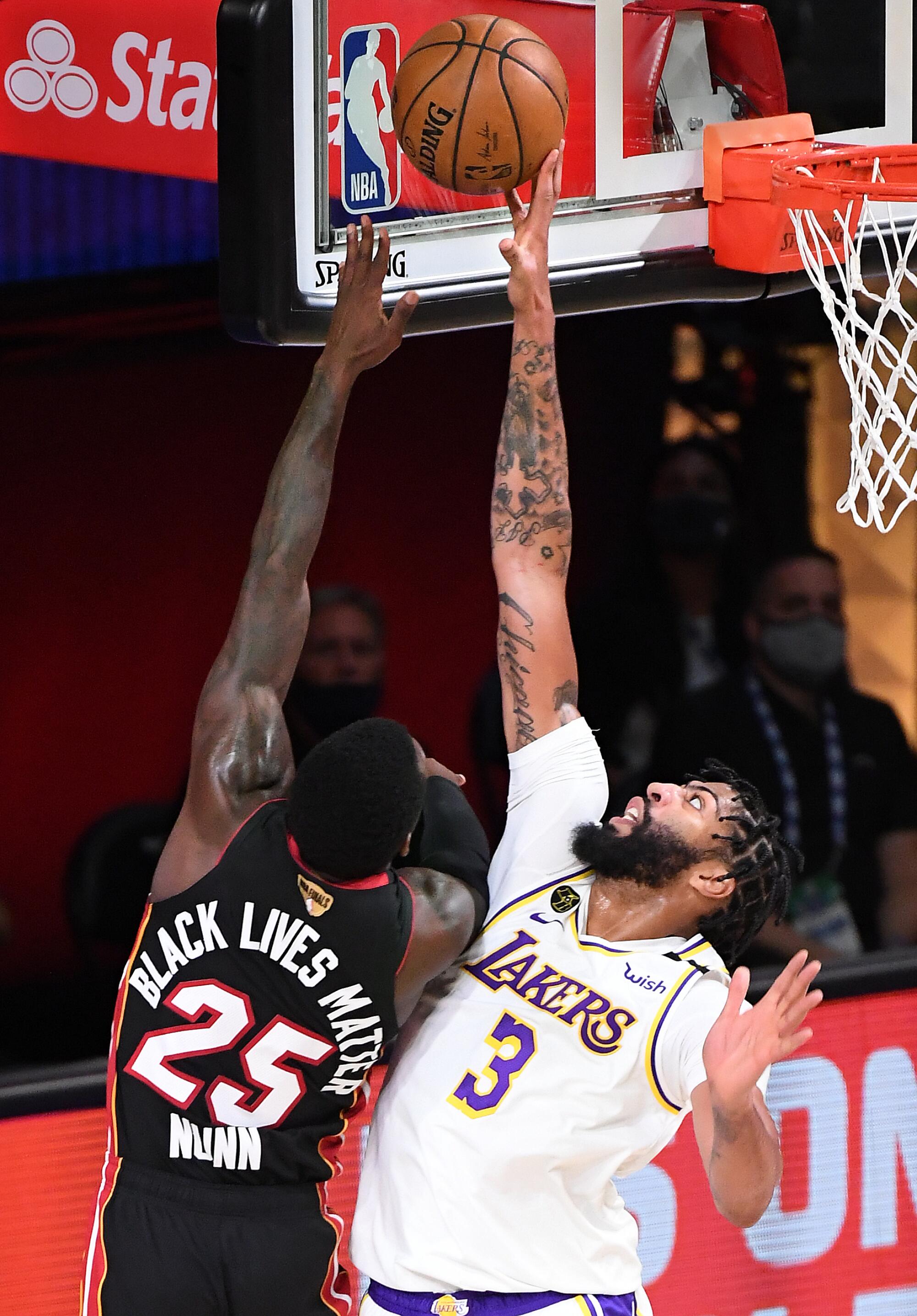 Lakers forward Anthony Davis blocks a shot by Miami Heat guard Kendrick Nunn.