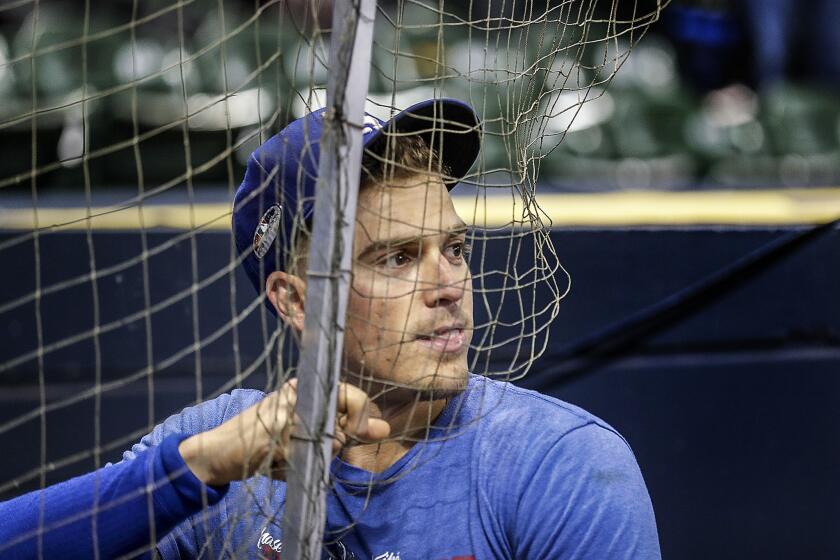 Dodgers second baseman Kiké Hernández takes a break during batting practice before game one.
