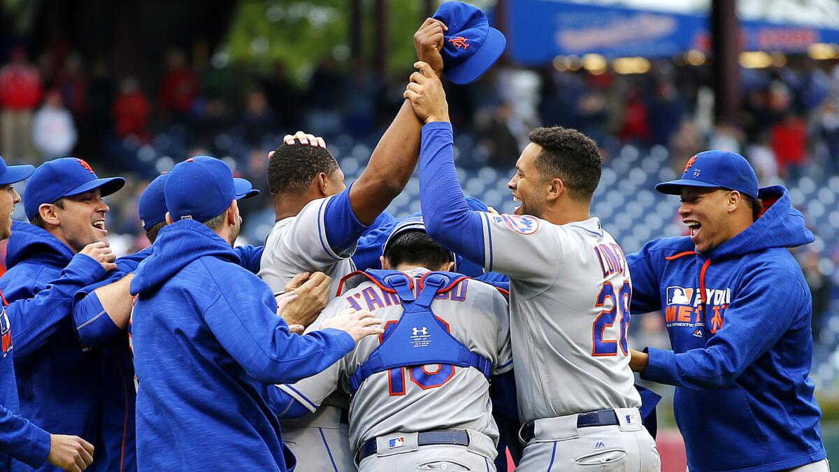 Mets players celebrate after defeating the Phillies on Saturday to earn home-field advantage in the NL wild-card game.