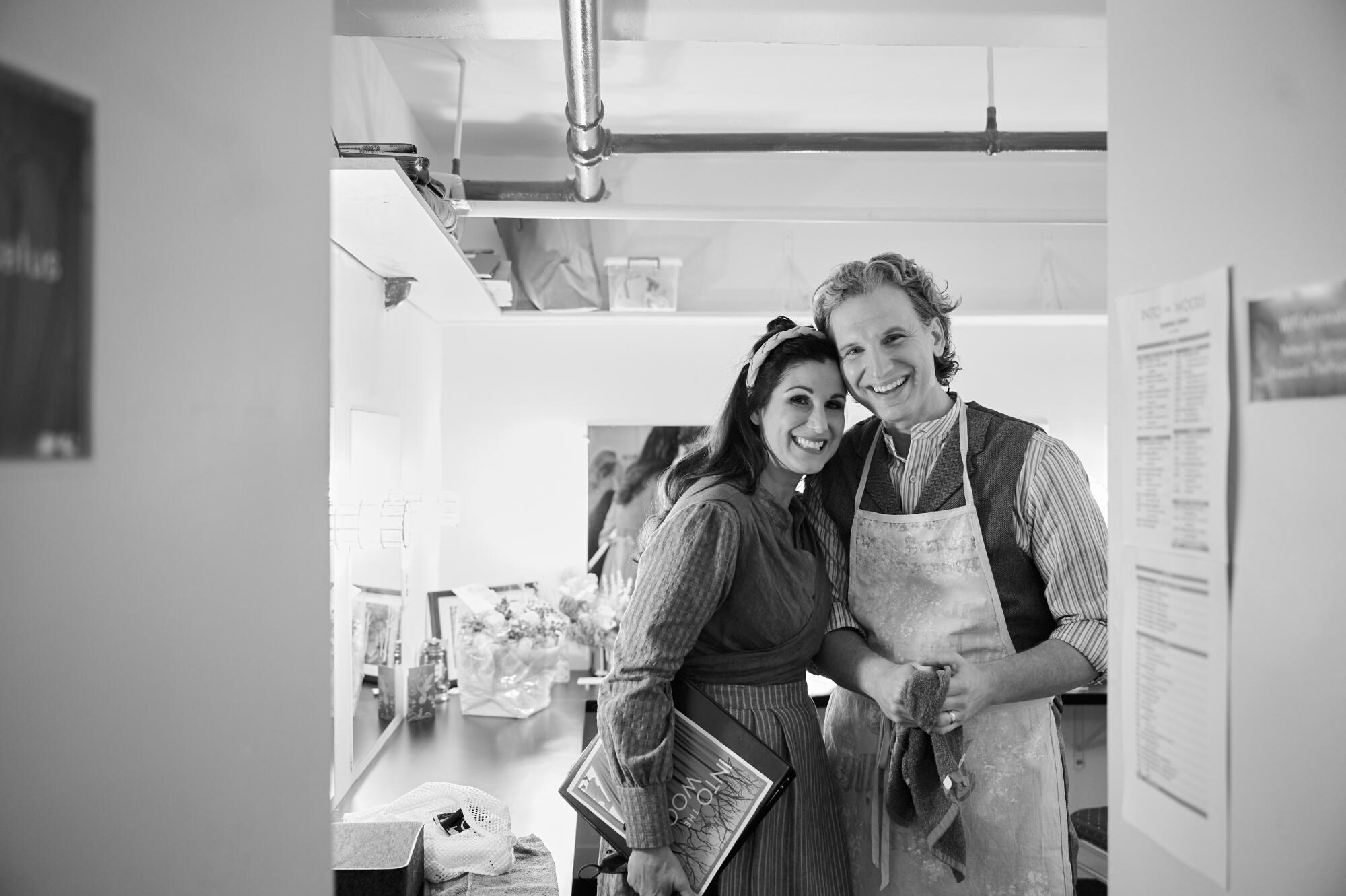 A black-and-white photo of a couple in a theater dressing room