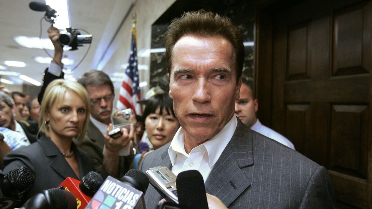 Then-Gov. Arnold Schwarzenegger responds to a reporter's question on the state budget stalemate during a news conference outside his state Capitol office on Aug. 19, 2008.