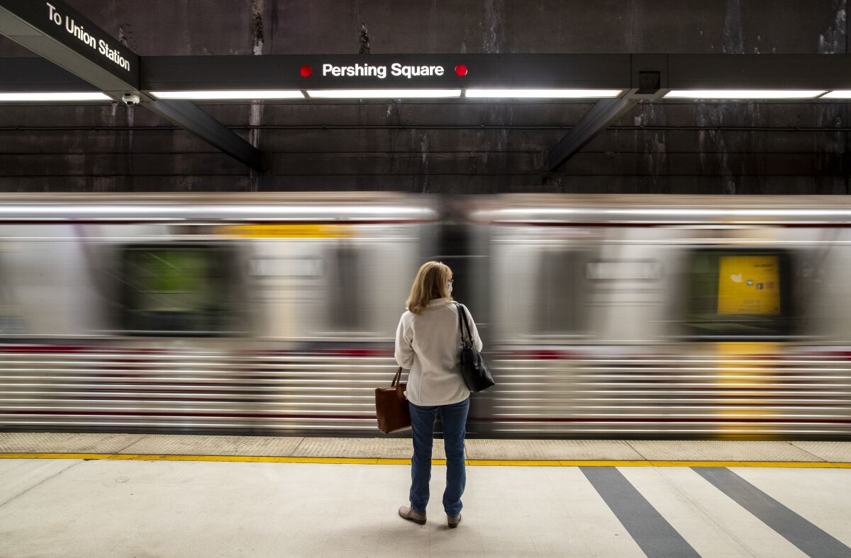 A commuter waits at the Pershing Square station in downtown Los Angeles for a Metro Red Line train