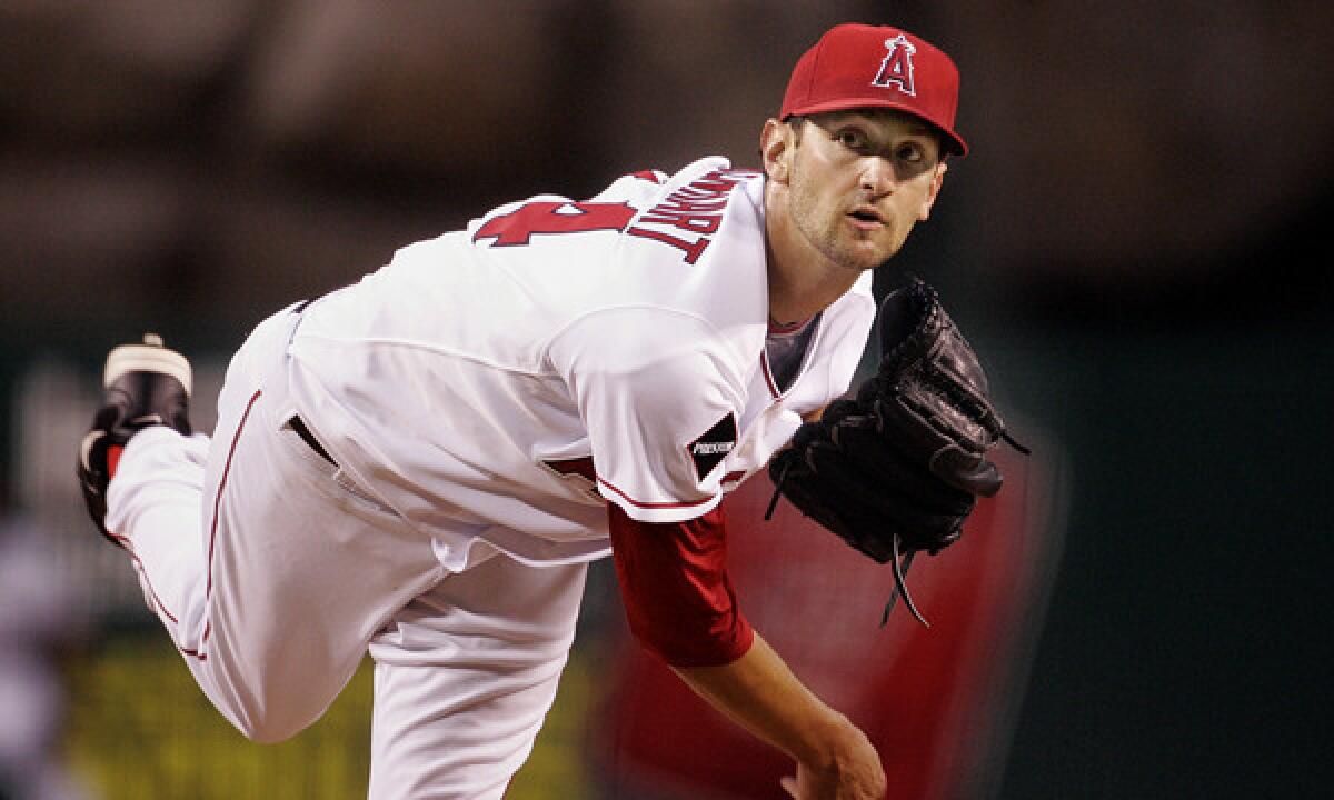 Angels pitcher Nick Adenhart delivers during a game against the Oakland Athletics on April 8, 2009. Adenhart was among three people killed in a car crash in Fullerton hours after the game.