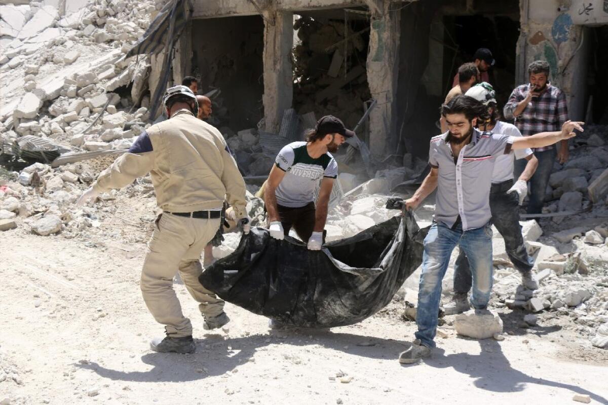 Syrian civil defense workers remove a body from the rubble of a building following reported airstrikes on rebel-head areas in Aleppo.